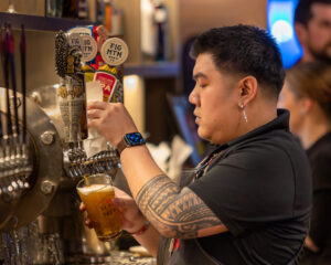 Pouring beer.