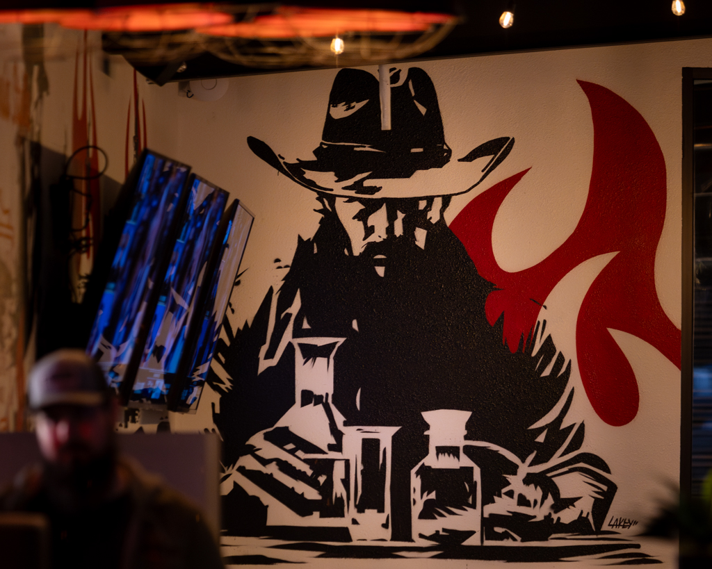 Cowboy painting on the wall.